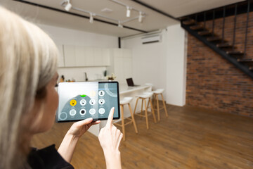 Poster - Smart home control on tablet. Interior of living room in the background