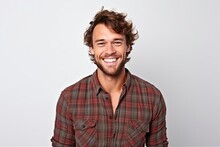 Handsome Young Man In Checkered Shirt Smiling And Looking At Camera.