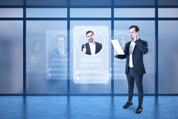 Sticker - Attractive businessman using laptop and creative worker ID hologram in blurry office interior with panoramic windows. Specialist search concept.