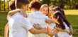 © Studio Romantic - Portrait of a happy children friends standing together outdoors, hugging and smiling in the park on holidays enjoying spending time in a summer camp. Team, unity and friendship concept. Banner.
