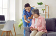© Studio Romantic - Elderly care. Friendly female caregiver shows elderly woman how to use modern mobile applications to monitor her health. Nurse and senior woman in nursing home are looking at mobile phone screen.