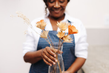 Wall Mural - Female florist holding a bouquet of handmade floral craft