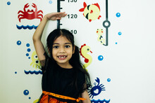 Cute Asian Little Girl Playing With Colorful Fishes On White Board