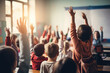 © Bojan - Rear view of young pupils with raised hands in elementary school classroom.