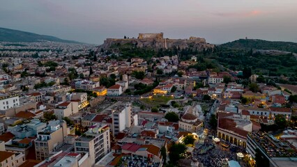 Wall Mural - Aerial time lapse view of the illuminated old town of Athens Plaka with Monastiraki square and the Acropolis during sunset and dusk