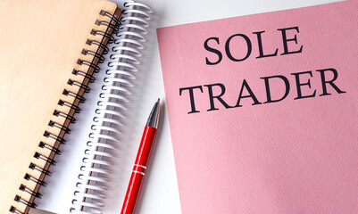 Poster - SOLE TRADER word on the pink paper with office tools on white background
