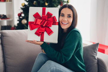 Canvas Print - Photo of charming excited lady dressed knitted x-mas sweater rising gift box sitting sofa indoors house room