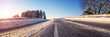 Beautiful winter road in natural sunny park.