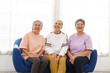 © artitwpd - The group of happy and healthy three Asian senior women sits together on a sofa. Smiling and laughing together.