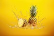 fresh pineapple with splashing water on yellow background