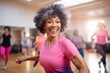 © Markus Schröder - Sports portrait photography of a serious mature woman dancing in a zumba class. With generative AI technology