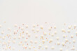 White sugar sweet snowflakes sprinkles on white background. Sweet backing decoration for cake and candy.Copy space. 