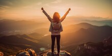 Positive Woman Celebrating On Mountain Top, With Arms Raised Up.