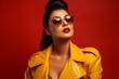 a beautiful exotic woman with bright red lipstick on her lips, wearing a yellow leather suit and a big pair of orange sunglasses