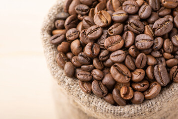 Canvas Print - Close up of coffee beans in linen sack. Roasted aromatic coffee grain in bag made of linen fiber