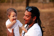 © Austockphoto - Happy Aussie baby girl with aboriginal father smiling together in soft sunset light