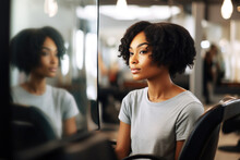 Portrait Of A Young Black Woman Looking At Her New Haircut In Mirror In The Hair Salon