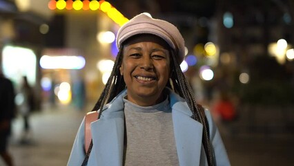 Wall Mural - Elderly african woman enjoy day in the city during winter time
