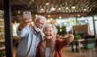 © annebel146 - Happy Cheerful senior couple taking selfie on modern smartphone while standing on street. Concept of family, technology and elderly. Happy grandma and grandpa with modern technology