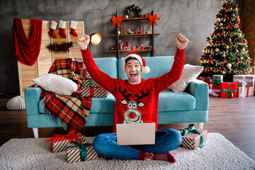 Canvas Print - Full length photo of handsome satisfied guy sit carpet raise fists buy order newyear giftbox netbook festive spirit house indoors