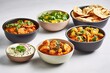 Bowls of indian food on light background
