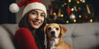 Merry Christmas and Happy New Year - Happy woman in santa hat hugging cute dog at stylish christmas tree. Pet and winter holidays, generative ai