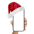 © vovan - a phone  in a hand with a Santa Claus hat for Christmas on a transparent background in PNG format
