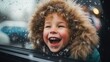 Happy little boy watching and playing with snow from an open car window on the trip of a snowy winter holiday, joyful kid have fun with snow flakes.