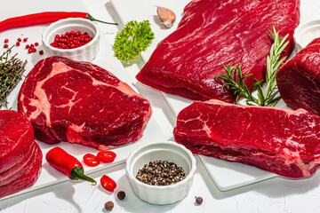 Wall Mural - Set of various steaks with spices and herbs. Ribeye, eye round, flank and striploin steaks