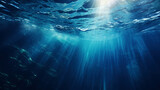 Fototapeta  - Sun shining light in blue clearly deep water, sunbeams illuminate the blue underwater sea scene, background