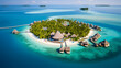 An aerial view of a private island resort with overwater villas and pristine beaches.