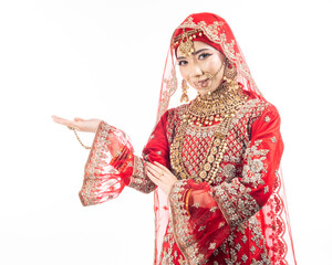 Wall Mural - Close up portrait of a beautiful Asian Muslim lady in a hijab wearing a gorgeous Bollywood or Indian themed red traditional wedding dress isolated on white background