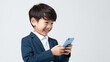 © Studio Nova - Little smiling boy with a cell phone on a colored background.