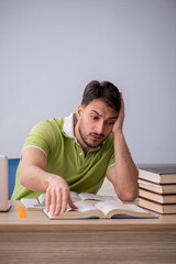 Wall Mural - Young male student sitting in front of whiteboard