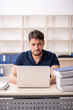 © Elnur - Young male employee sitting at workplace