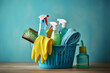 Bucket and cleaning products on a blue bathroom background. Washing brush and spray set with copy space.