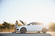 © Serhii - Young sexy woman with broken car calling on the cell phone.