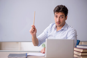 Wall Mural - Young male teacher in front of white board