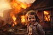 Creepy looking kid girl smirking in front of burning house