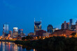 Scenic View of Broadway district of Nashville over Cumberland River at illuminated night skyline, Tennessee, USA. This city is known as a center for the music industry, especially country music