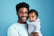 African-american father and son portrait on gradient studio background in neon. Beautiful male models in casual style, white shirt. Concept of human emotions, facial expression