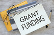 Grant funding symbol. text on a page in two notepads.. Business and grant funding concept. Copy space.