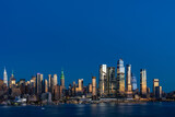 Fototapeta Miasta - Aerial New York City skyline from New Jersey over the Hudson River with the skyscrapers of the Hudson Yards district at night. Manhattan, Midtown, NYC, USA. A vibrant business neighborhood