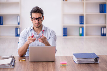 Wall Mural - Young male employee in e-commerce concept