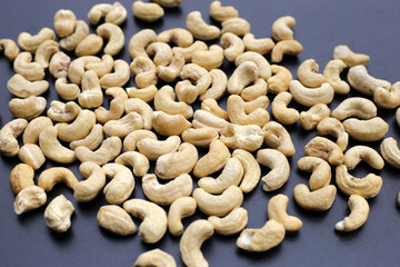 Cashew nuts on dark background.