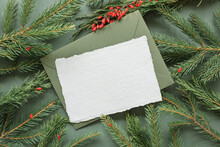 Overhead View Of A Blank Card And Envelope On Fir Branches And Berries
