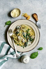 Wall Mural - Pasta with spinach and mushrooms in a cream sauce. Top view with copy space.