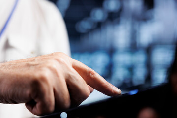 Poster - Cloud computing business executive using laptop to examine servers for power fluctuations, close up. Adept worker monitoring high tech data center components, identifying potential glitches