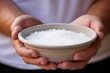 Closeup of a baptismal candidate holding a small bowl of salt, which will be used to symbolize their calling to be the salt of the earth.