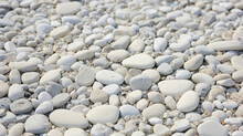 Closeup Of A Smooth Exposed Aggregate Concrete, Revealing Its Smooth And Polished Surface With Hints Of Embedded Stones And Pebbles.